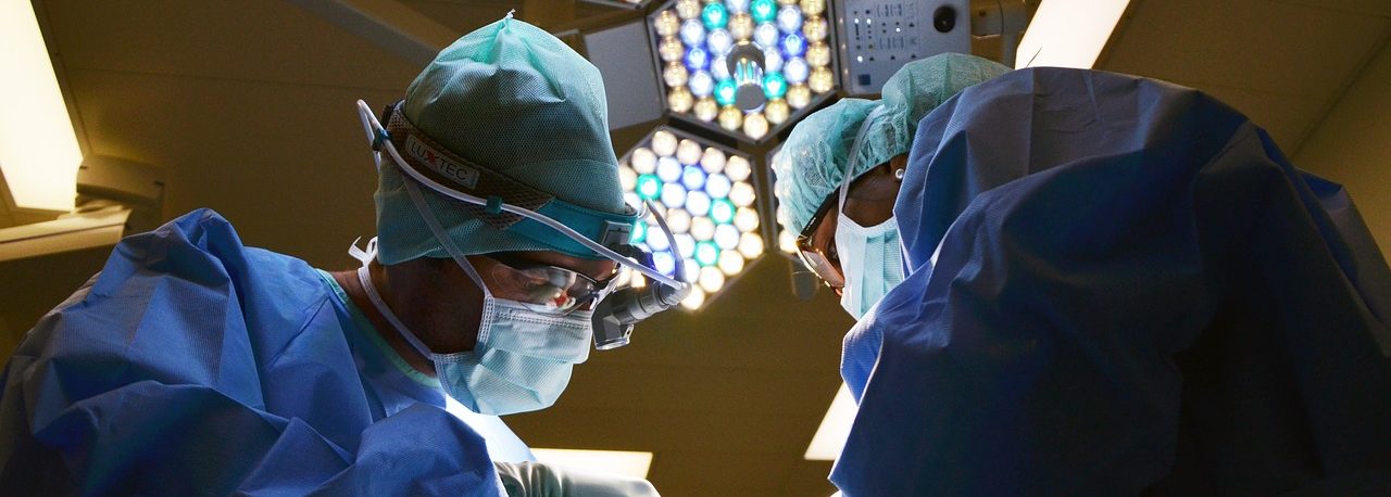 two surgeons operating under a light